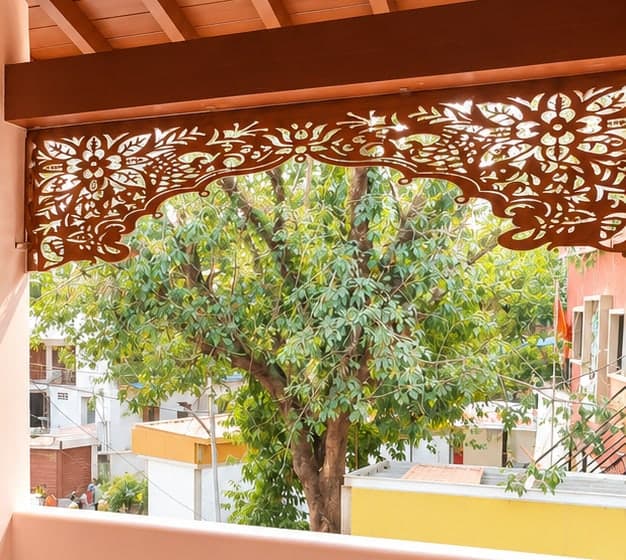 Close view of the hand-carved floral wooden jaali above the balcony