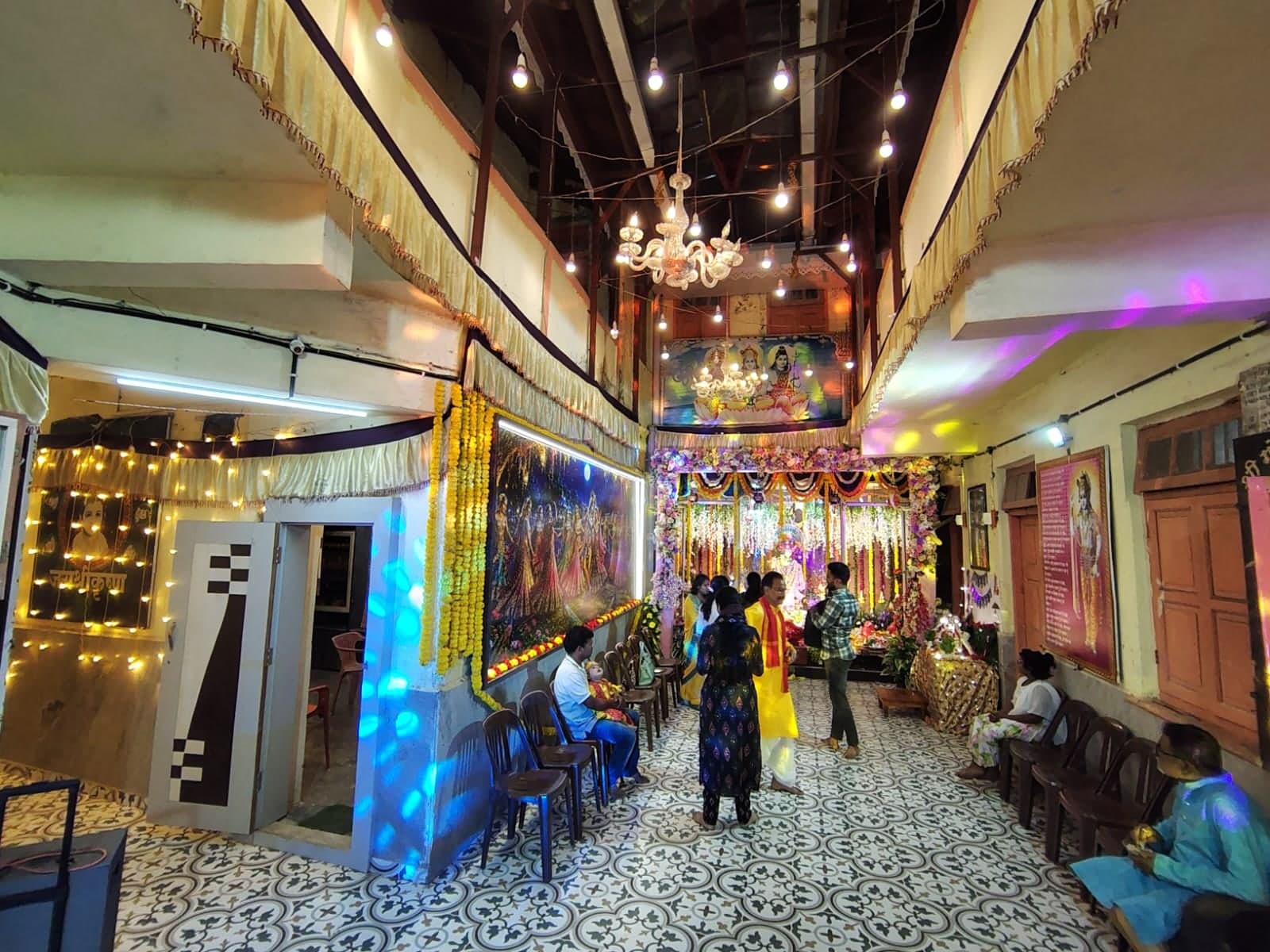 Devotees gathered in the festively lit courtyard leading to the mandir